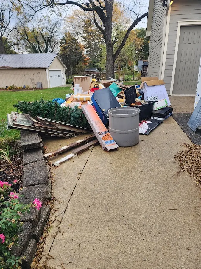 Dumpster being loaded with debris for Commercial Dumpster Rental in Mead